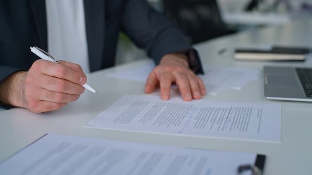 Close up male hands writing notes business paperwork noting law financial documentation in papers unknown Caucasian manager man write signing documents businessman entrepreneur at table in office
