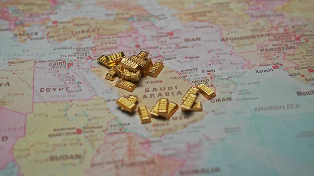 Gold bars on Saudi Arabia map wealth and finance concept.