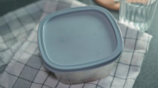 A hand removes a sticky note reading 'Empty' from a container in a kitchen. The person is angry and frustrated by the lack of food