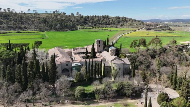 Catalunya Monastir de Sant Benet de Bages landscape with historic monastery. Captivating aerial view featuring lush greenery and ancient architecture. A tranquil spot in the countryside.