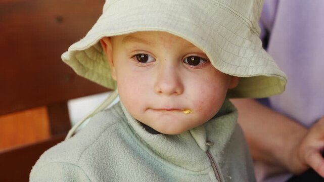 Child enjoys meal while being fed with care in a simple setting