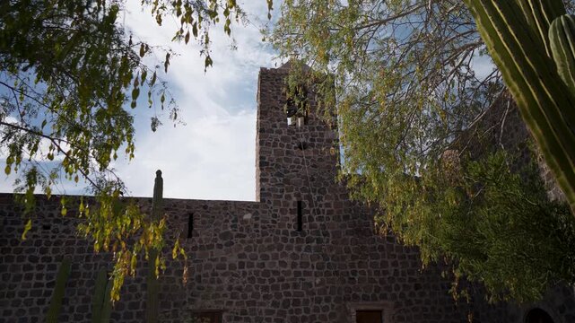Explore Mission Church Santa Rosalia located in Mulege Baja California Sur Mexico amid palm trees and desert mountains.