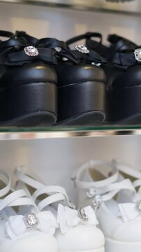 Rows of stylish platform heels with crystal embellishments on display in retail shoe store.