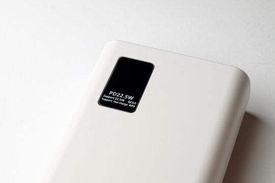 Modern power bank offering efficient charging on a sleek white surface