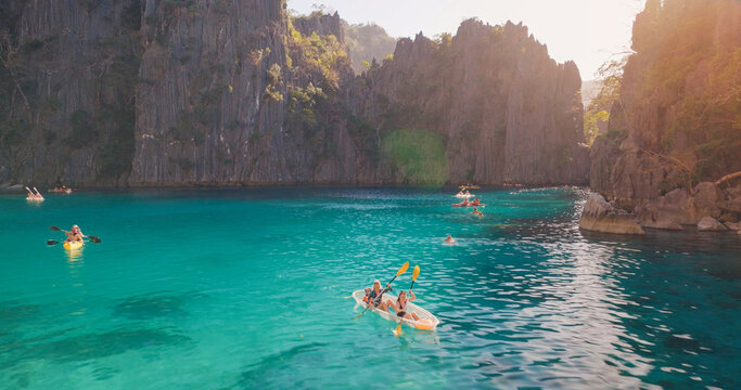 Tourists kayaking kayangan lake turquoise water coron philippines