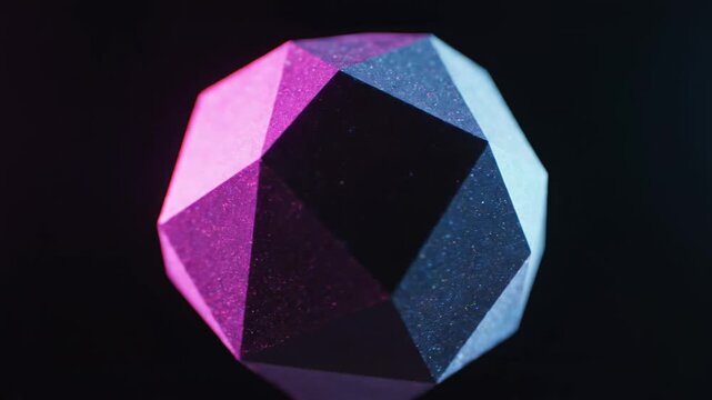 A geometric polyhedron with many faces, illuminated by vibrant pink and cool blue neon lights, creates a striking visual contrast against a dark, moody, and abstract atmospheric setting
