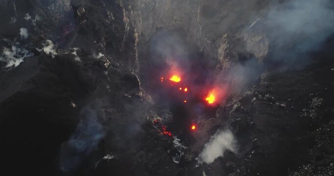 Aerial view Mount Yasur volcano on Tanna Island, Vanuatu, erupting, explosions of glowing hot lava and plumes of smoke rising from active crater, showcasing raw natural power and geological activity