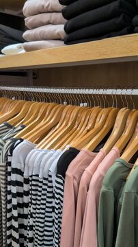 Assorted top and clothing on a shelf in a clothing store