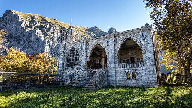 View of Eremo di San Leonardo al Volubrio with its stone facade and gothic arches under restoration against the Sibillini Mountains Rubbiano, Marche, Italy.