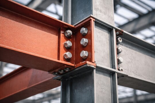 Steel beam assembly featuring bolted connection and metal primer coating