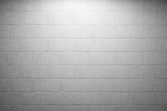 Rough gray cinderblock wall painted backdrop illuminated by high key lighting copy space