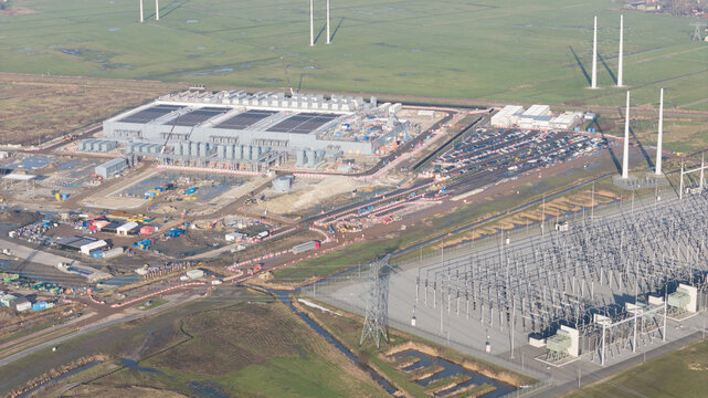 Groningen, Netherlands - 20 January 2026: Aerial view of Datacenter Westpoort featuring the large industrial facility, parking area, and electrical substation in the countryside.