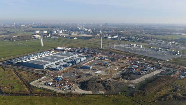 Groningen, Netherlands - 20 January 2026: Aerial view of Datacenter Westpoort featuring the large industrial facility, construction area, and surrounding green fields.