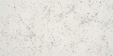 Fototapeta premium White speckled stone surface. Close-up of a white textured material with grey speckles, ideal for backgrounds and design projects.