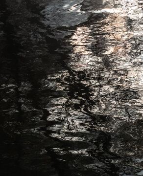 Dark water reflection texture in black and white - Moccasin Trail Park, Toronto, Ontario, Canada