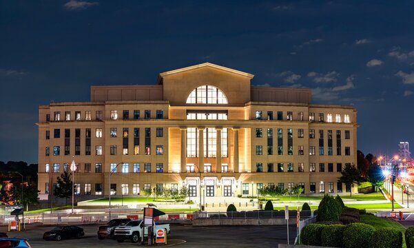 Atlanta, Georgia - August 27, 2025: Nathan Deal Judicial Center, a modern government building featuring a stone facade with columns and large glass windows illuminated at night