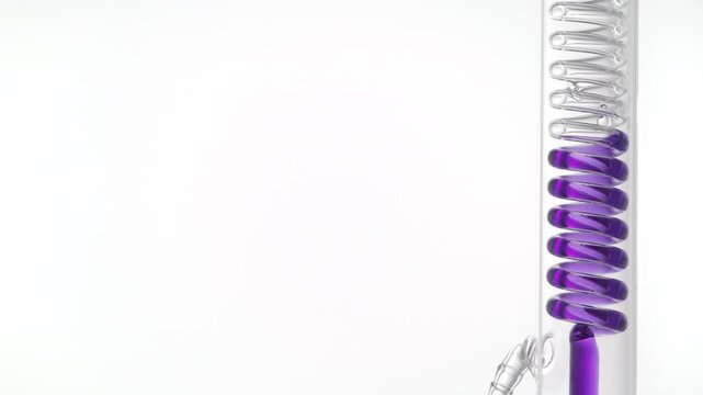 Violet clear fluid flows through a vertically mounted coil lab condenser, visibly filling the coiled glass tube on the right side of the frame, leaving the left side for copy space on white surface