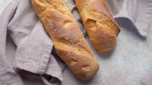 Freshly baked french baguettes resting on linen