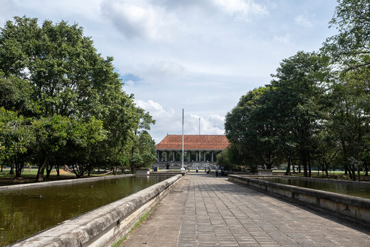 12.09.2025 Colombo, Sri Lanka. Long stone walkway leading to Independence Memorial Hall pavilion with ponds and trees in Colombo, Sri Lanka.