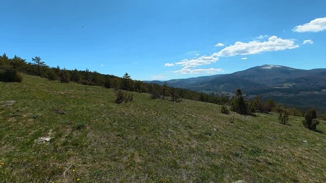 Wide grassy hill under clear blue sky. Mount Goc, Ljukten peak. Balkans, Serbia