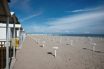 Empty Autumn Beach With Closed Bathhouse Cabins And Umbrella Stands – Bibione Off-Season Landscape