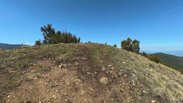 Clear blue sky above grassy hilltop. Mount Goc, Ljukten peak. Balkans, Serbia