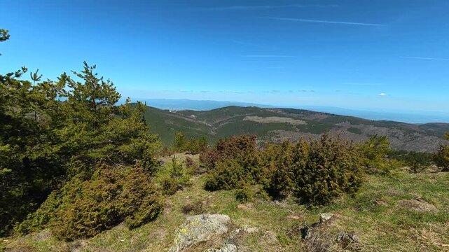 Sunlit hilltop overlooks distant sea. Mount Goc, Ljukten peak. Balkans, Serbia
