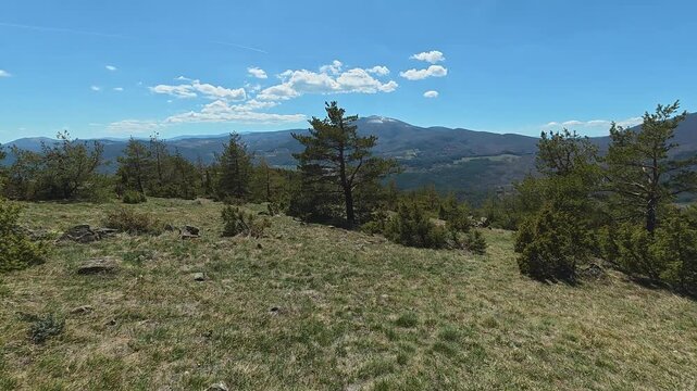 Clear blue sky with scattered white clouds. Mount Goc, Ljukten peak. Balkans, Serbia