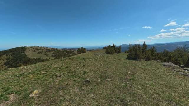 Clear blue sky above rolling green hills. Mount Goc, Ljukten peak. Balkans, Serbia