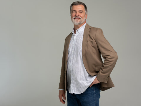 Entrepreneur in jacket smiling, Happy mid adult, mature age man standing, smiling