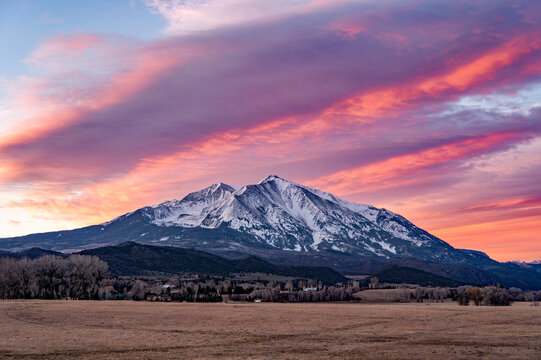 Mount Sopris near Carbondale, Colorado under colorful sunrise cloudscape in early spring morning.