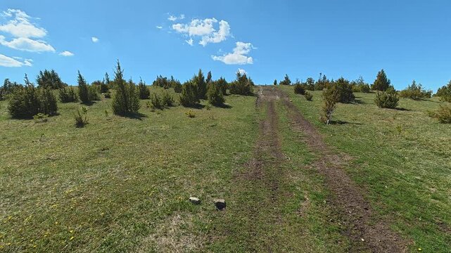 Grassy hill rises under clear blue sky. Mount Goc, Ljukten peak. Balkans, Serbia