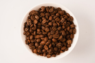 Fototapeta premium Coffee beans on a white background. Top view. Coffee beans texture.