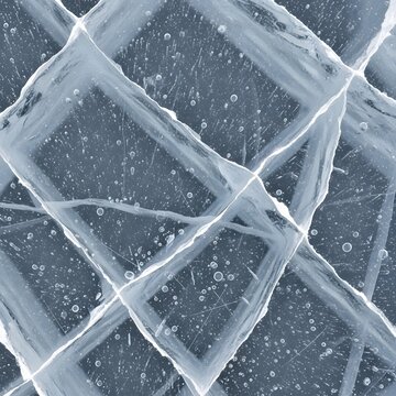 Close up view of blue frozen ice texture with white cracks and air bubbles trapped inside.