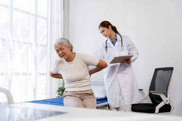 Obraz premium Female patient feeling severe backache, a young doctor standing by with a clipboard for healthcare examination in clinic
