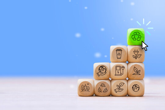 Recycling and sustainability concept with eco icons on wooden blocks, green recycle symbol and cursor click on blue background. Environmental protection, renewable energy and ESG banner design.