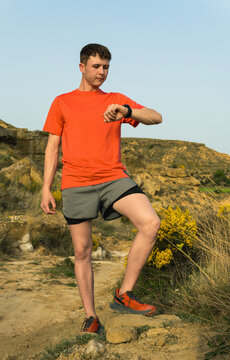 Trail runner checking smartwatch during outdoor training