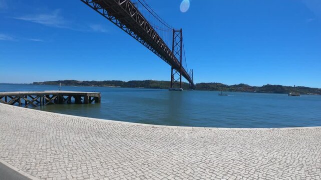 Christ-King and the 25 April Bridge (Ponte 25 de Abril), a steel suspension bridge located in Lisbon, Portugal, crossing the Tagus River (Rio Tejo).