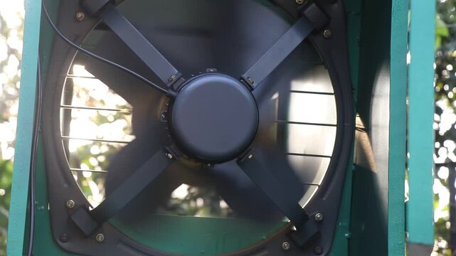 Spinning of exhaust fan blades inside the blower machine used to blow dust and other objects from the crops. AC Motor with propeller working