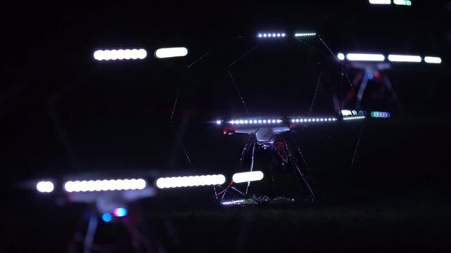 Nighttime drone light show with illuminated aerial vehicle performing stunts