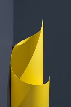 Espiral de papel fluido ondulado amarillo abstracto enrollado sobre fondo gris