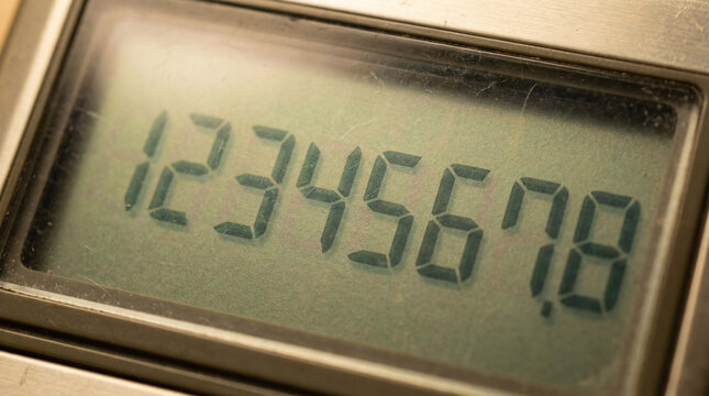 Vintage Calculator LCD Display Macro Shot. Extreme close-up of retro calculator LCD screen showing numbers with visible pixel segments