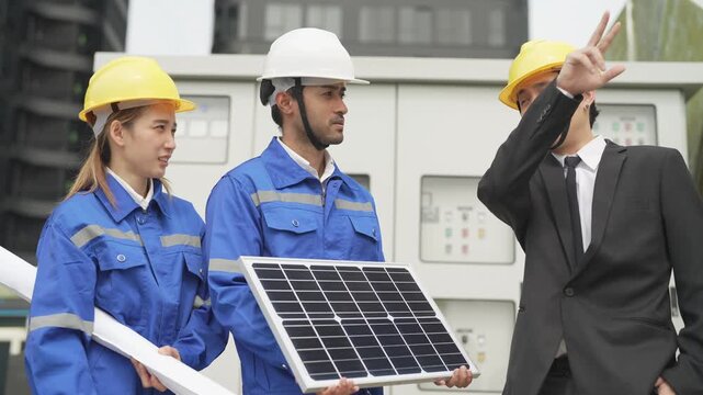 A professional male green building consultant in a business suit explaining mechanical ventilation workflows to a site engineer inside a facility pump room.