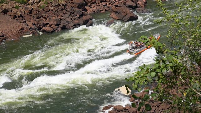 Thrilling boat tour at Iguazu Falls navigating upstream through the powerful white water rapids of the Iguazu River, an extreme adventure in South America