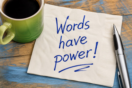 Words have power message written on a napkin with coffee and pen