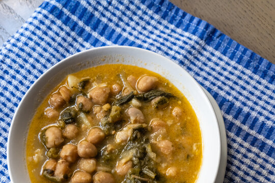 Chickpea and greens stew in white bowl