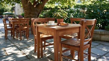 Fototapeta premium Shaded outdoor cafe terrace with wooden tables and chairs, coffee and croissant