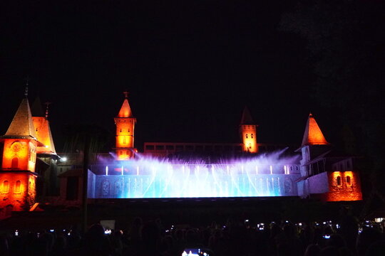 Colored musical fountains in the city park. Night time.