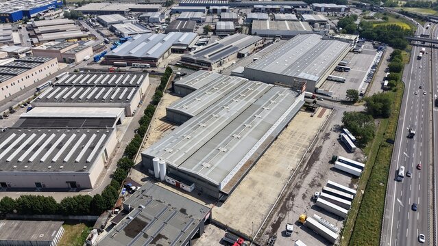 Industrial Park Aerial View: An expansive aerial view captures a sprawling industrial park with numerous warehouses, factories, and logistical facilities.