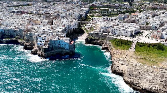Polignano a Mare with Lama Monachile beach. Aerial 4K drone video footage with panorama view of stunning coastal townscape in Puglia, southern Italy